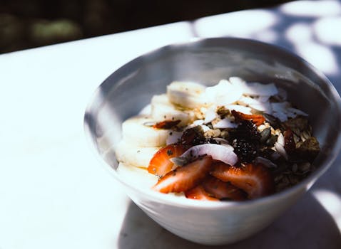 colorful bowl of mixed berries with coconut flakes