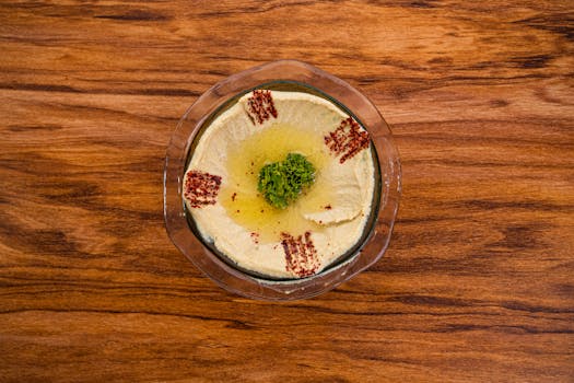 A colorful bowl of hummus with veggies